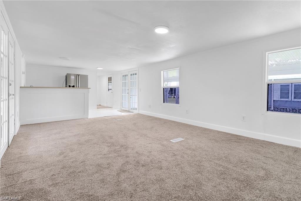 living room featuring carpet and baseboards