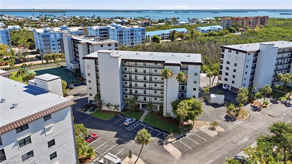Multi-story condominium building featuring a contemporary design with multiple balconies - Virtually Edited Image
