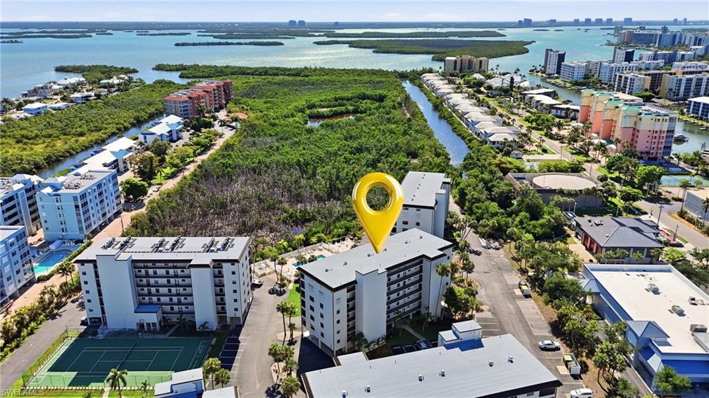 Multi-story building with multiple balconies, positioned near extensive waterways - Virtually Edited Image