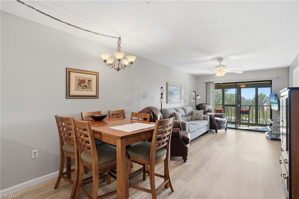 Open-concept living and dining area featuring light-toned wood-finish flooring - Virtually Edited Image