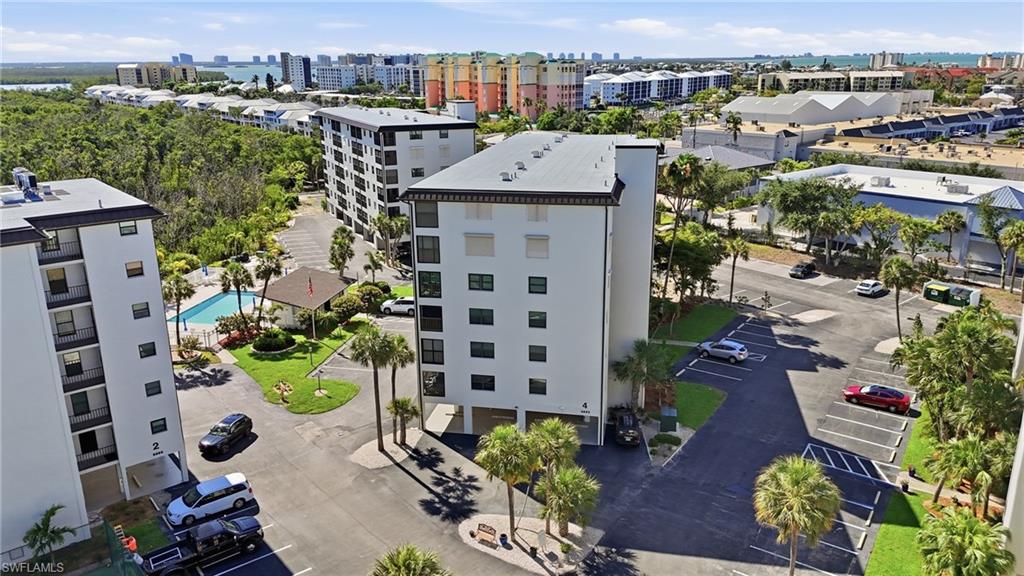 Multi-story condominium building featuring a white facade and dark trim - Virtually Edited Image