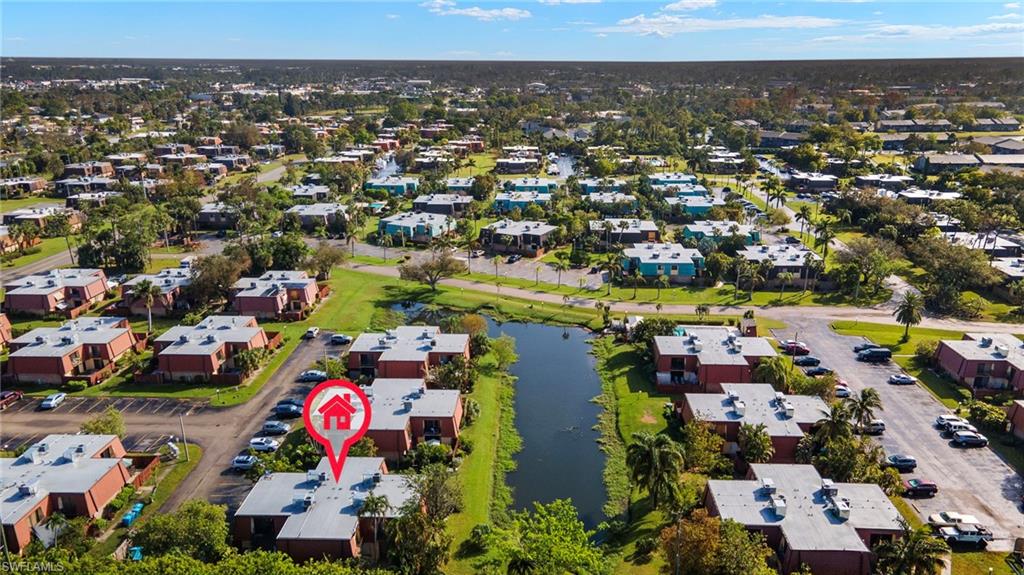 Aerial perspective showcasing a community with multiple residential buildings featuring red brick exteriors and light-colored roofs