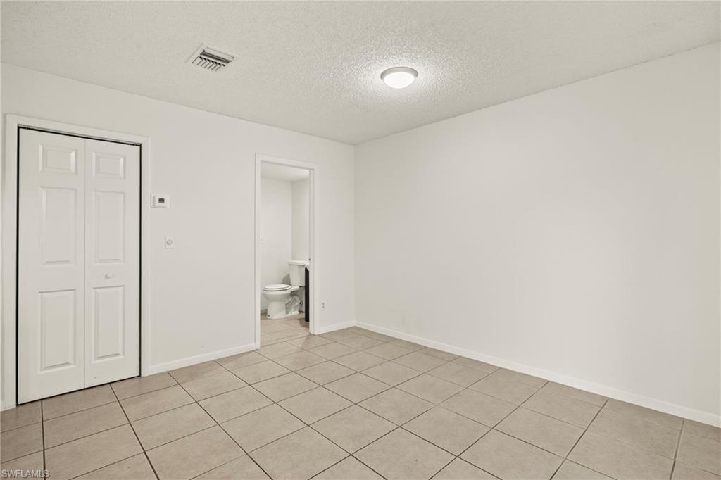 Light-colored tile flooring extending through the space