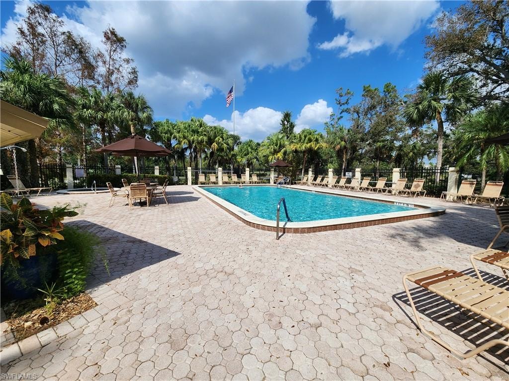 Rectangular swimming pool surrounded by a paver deck