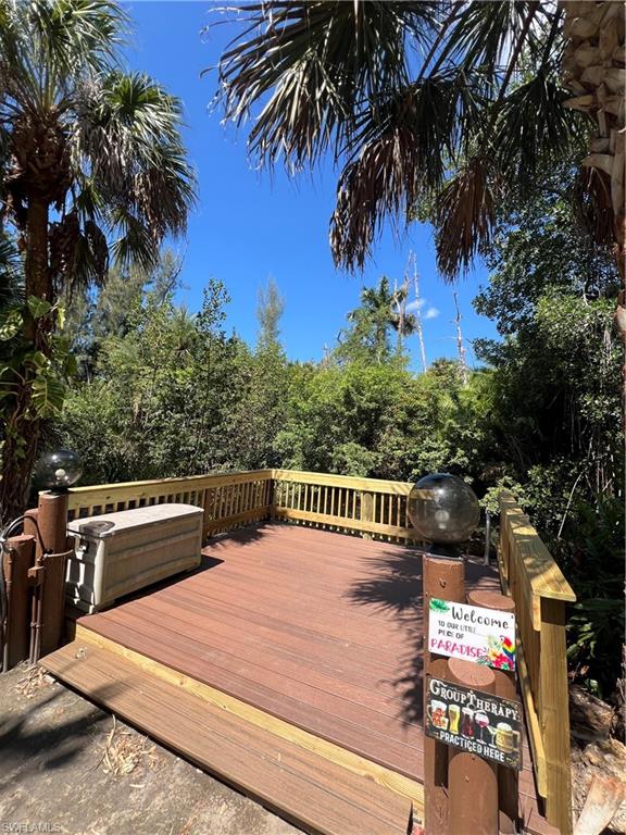 Expansive outdoor deck featuring composite wood-finish flooring and a natural wood railing
