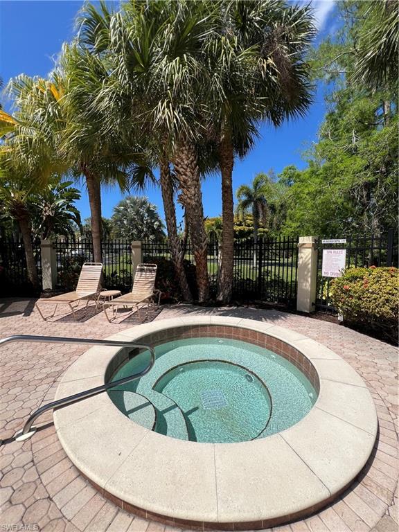 Circular spa with integrated steps, surrounded by paver decking
