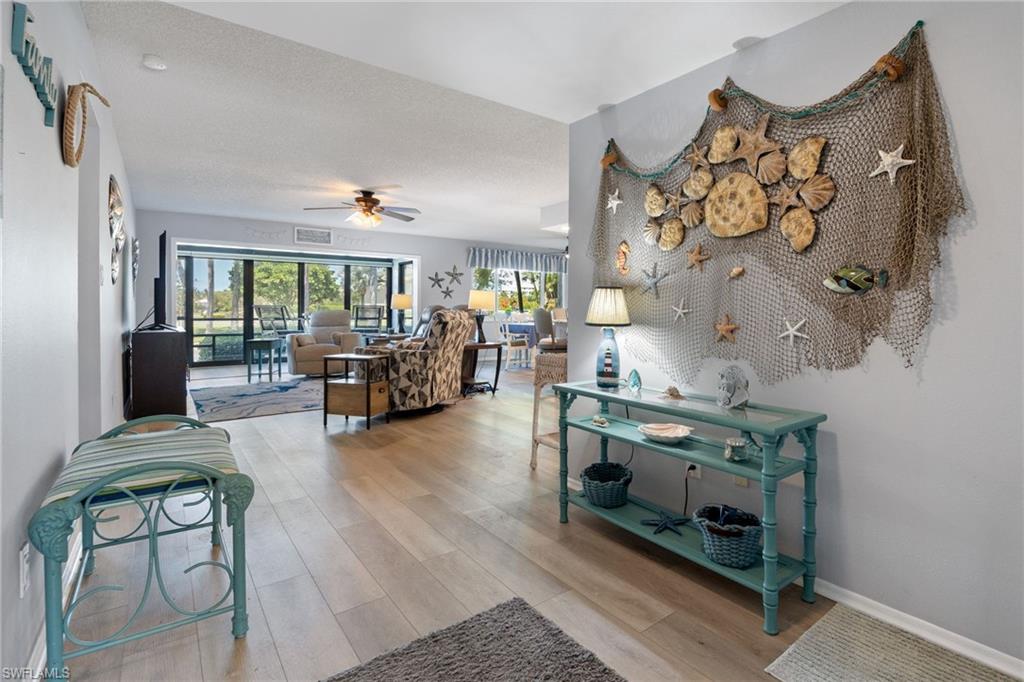 Open concept living space featuring wood-finish flooring and light-toned wall paint