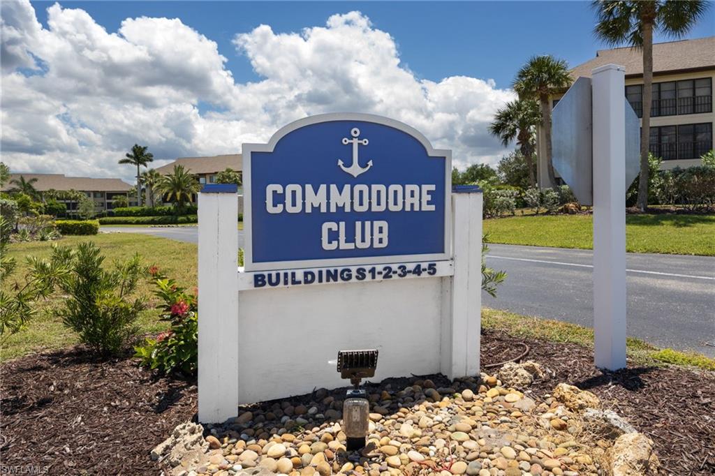 Commodore Club entrance sign featuring a blue and white color scheme with anchor motif