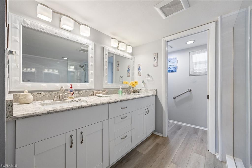 Dual vanity with light-tone countertops and under-mount sinks