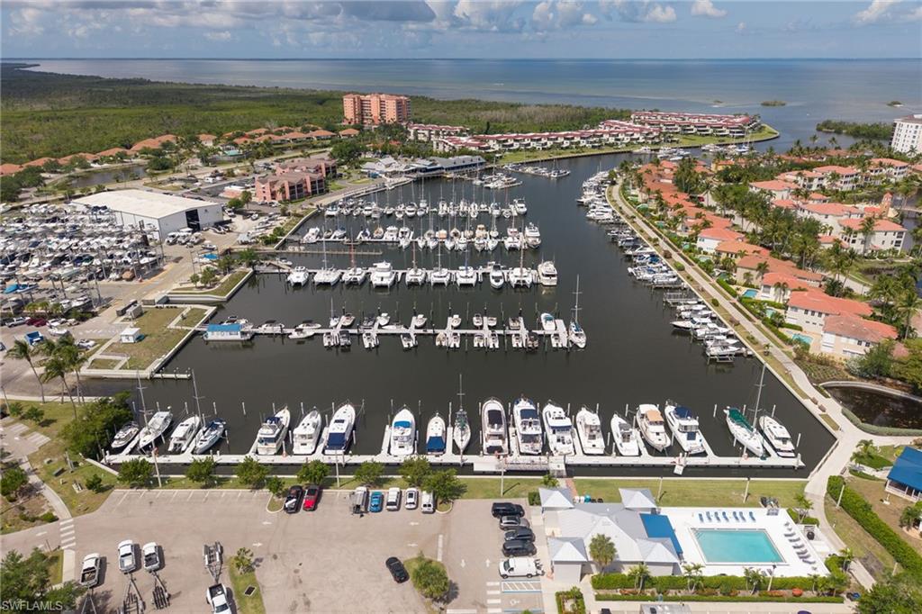 Expansive marina with numerous boat slips, surrounded by waterfront residential structures