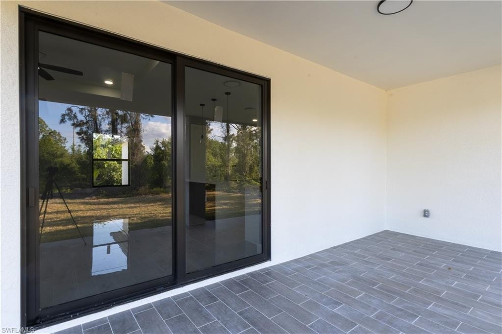 Entrance to property featuring stucco siding