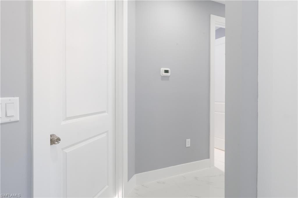 Hall featuring marble finish floors and baseboards