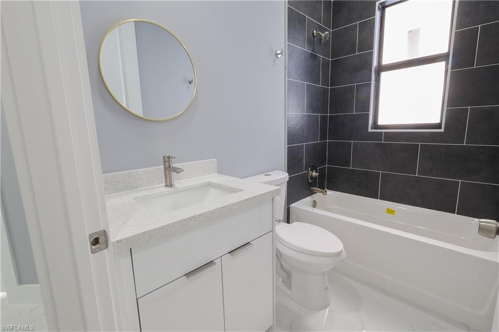 Bathroom featuring vanity and washtub / shower combination