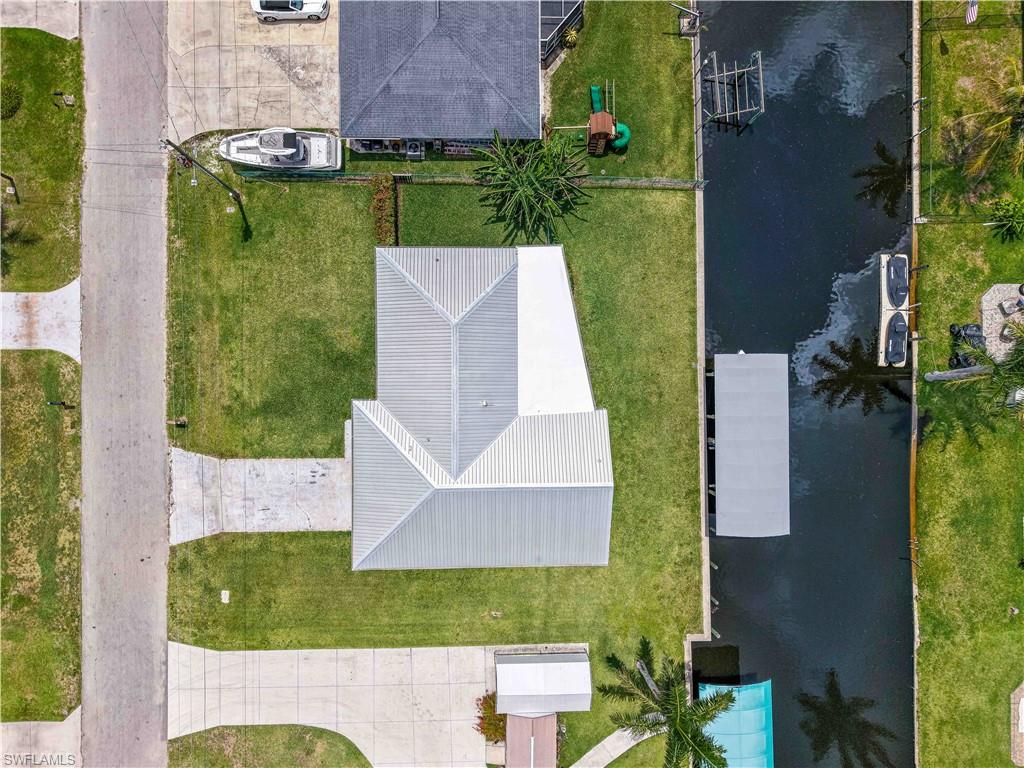 Waterfront property featuring a concrete seawall, and direct canal access