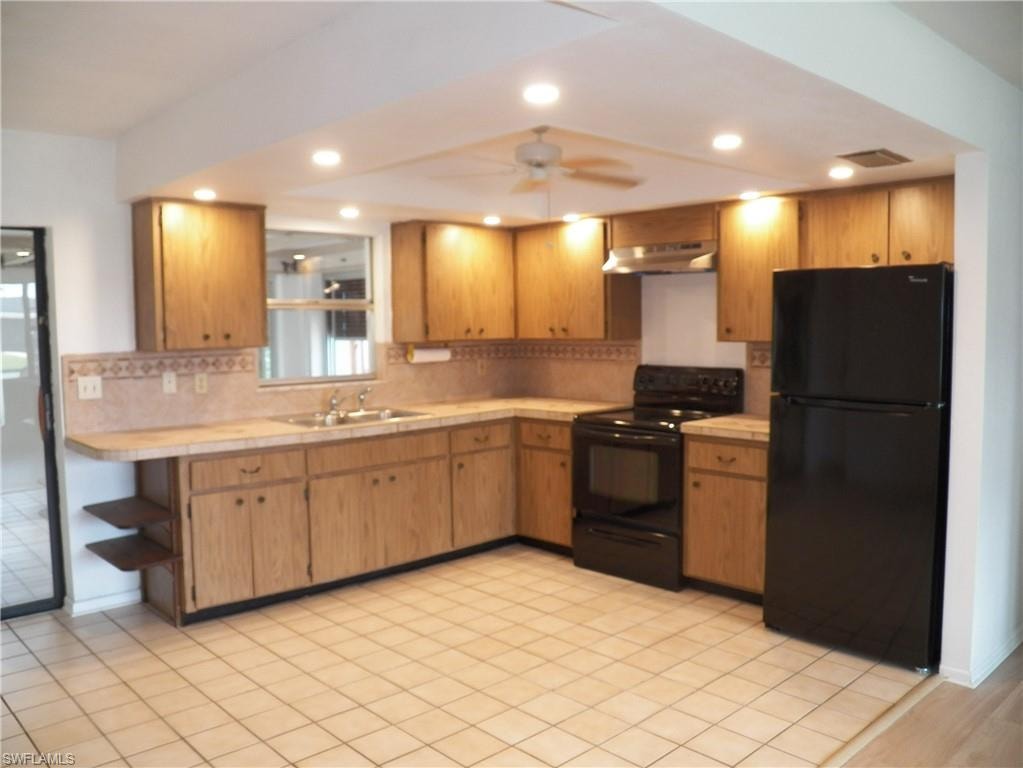 Recessed lighting and tile floor in the kitchen