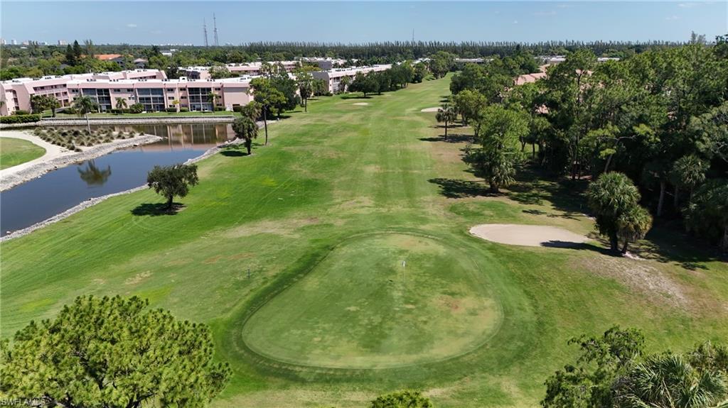 Expansive golf course with a manicured green and sand trap