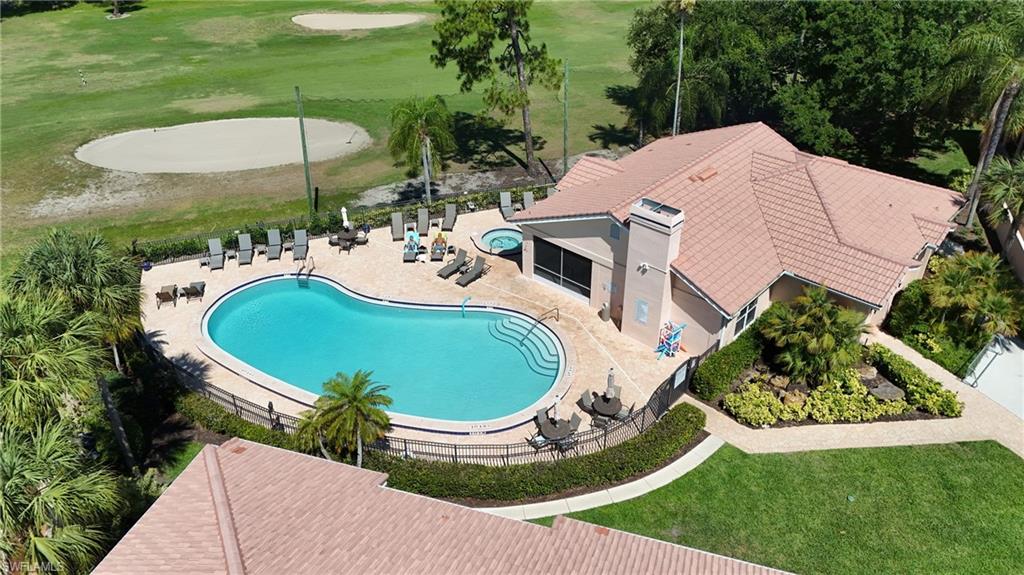 Outdoor swimming pool with integrated spa and paver surround