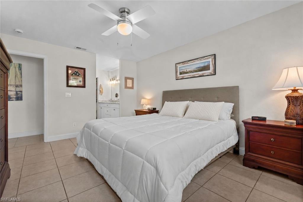 Bedroom featuring light tile flooring and a ceiling fan with integrated lighting
