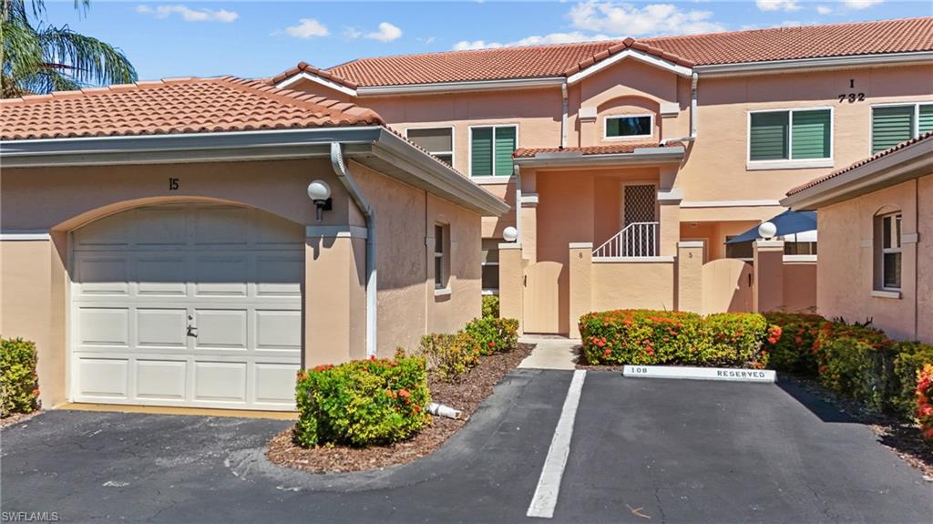 Mediterranean-style stucco exterior with a terra cotta tile roof