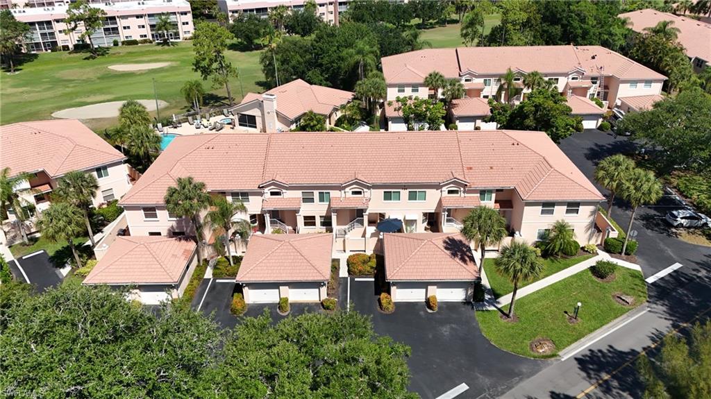 Aerial perspective showcasing a multi-unit residential complex with terracotta-style tile roofs