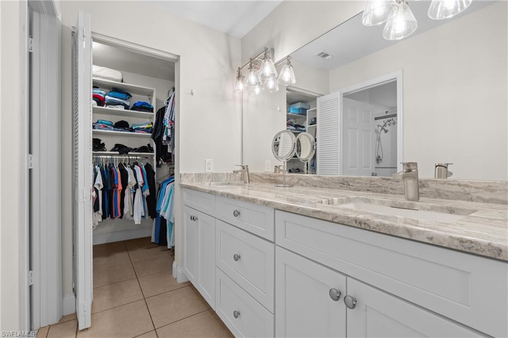 Dual vanity with an integrated sink, light-toned countertop, and modern fixtures