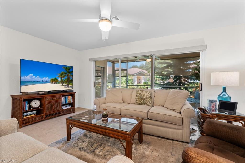 Living area featuring ceramic tile flooring and a ceiling fan with integrated lighting