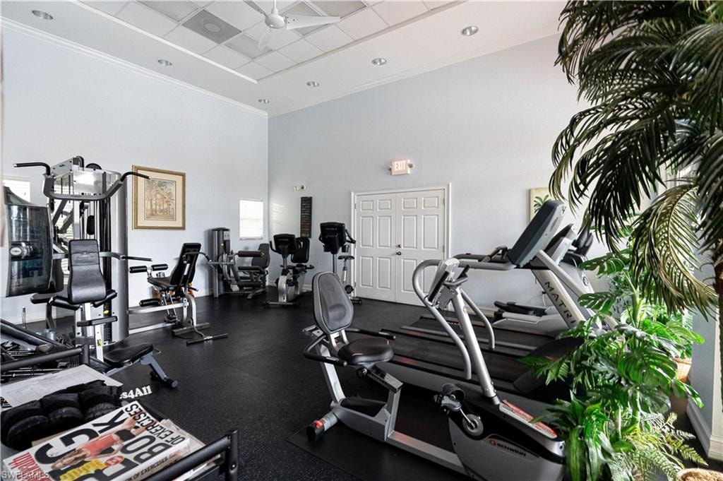 Workout area featuring a paneled ceiling and a high ceiling