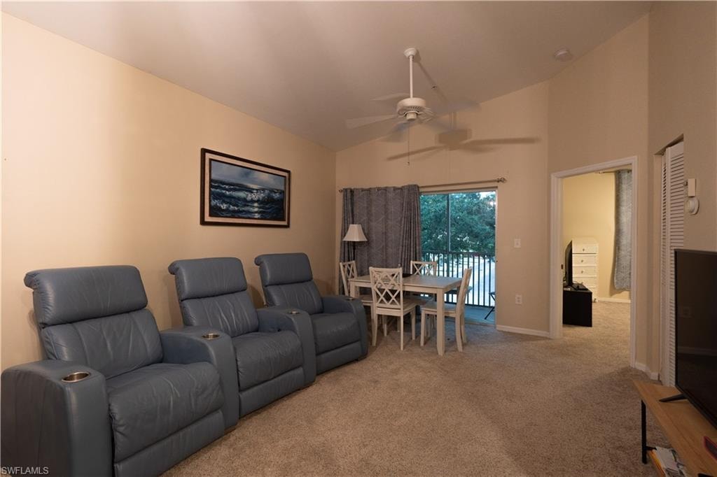 Home theater featuring high vaulted ceiling, ceiling fan, and carpet floors