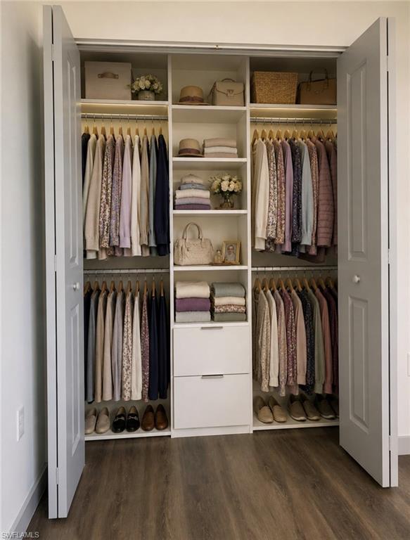 Built-in closet organization system featuring white cabinetry, multiple shelving units, and two integrated drawers
