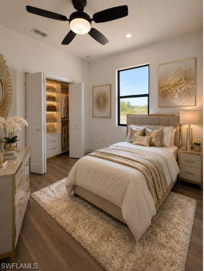 Bedroom featuring wood-finish flooring, a contemporary ceiling fan with integrated lighting, and a window with black trim