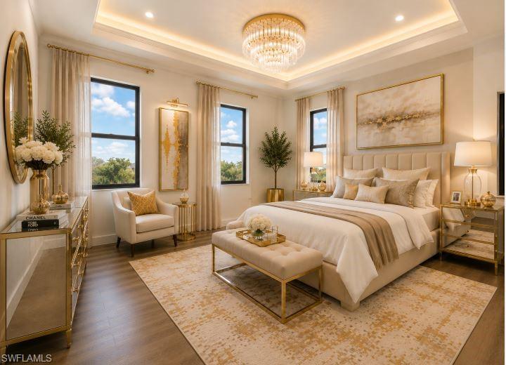 Recessed lighting within a tray ceiling, paired with a central chandelier, illuminates this space