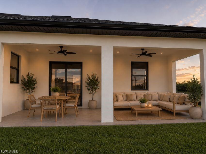 Expansive covered trussed in lanai featuring dual ceiling fans, a sliding glass door, and a large window Virtually Staged
