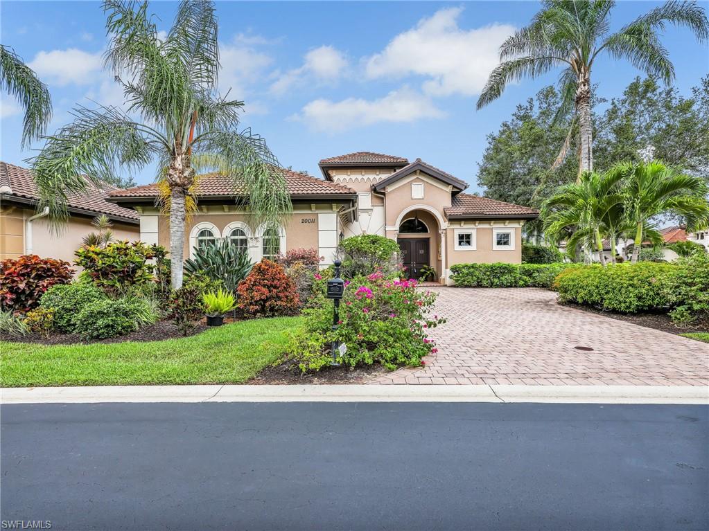 Front View with Lush Landscaping & Wide Paver Driveway