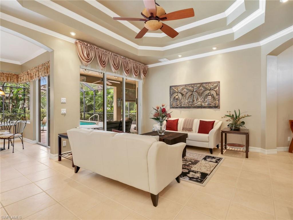 Formal Living Room & Eat-In Kitchen with Sliders to the Screened-In Lanai with a Pool View from Both Rooms