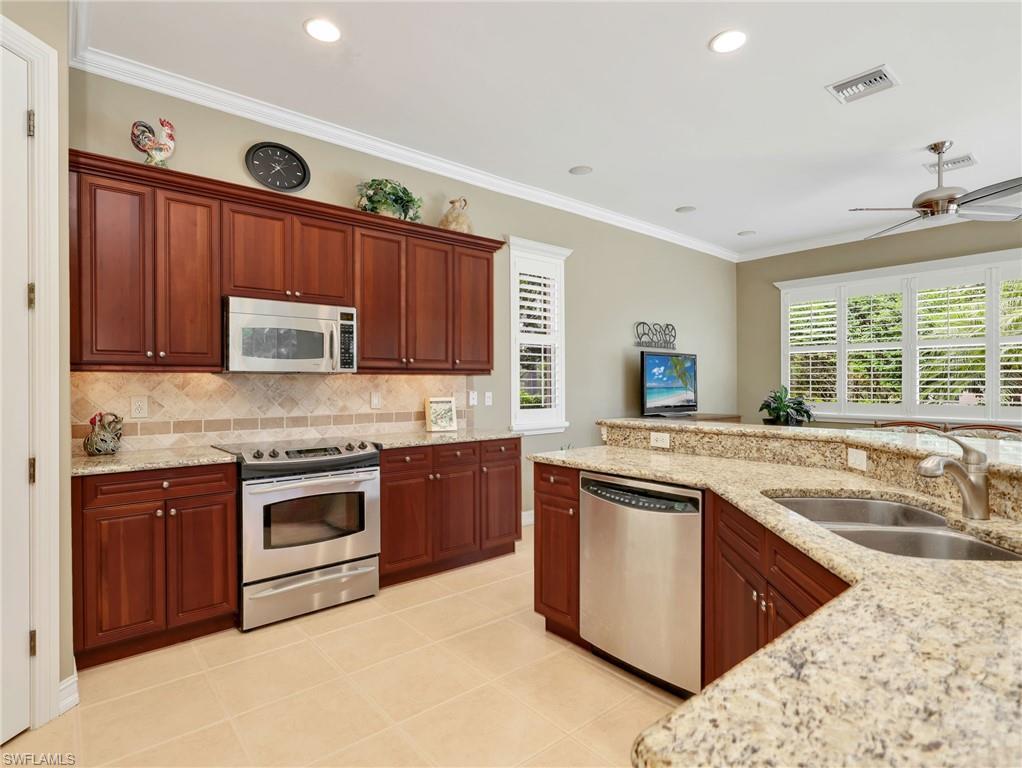 Kitchen with 42" Cabinetry, Stainless Steel Appliances and Sink, Granite Countertops, Tile Backsplash, Breakfast Bar & Pantry