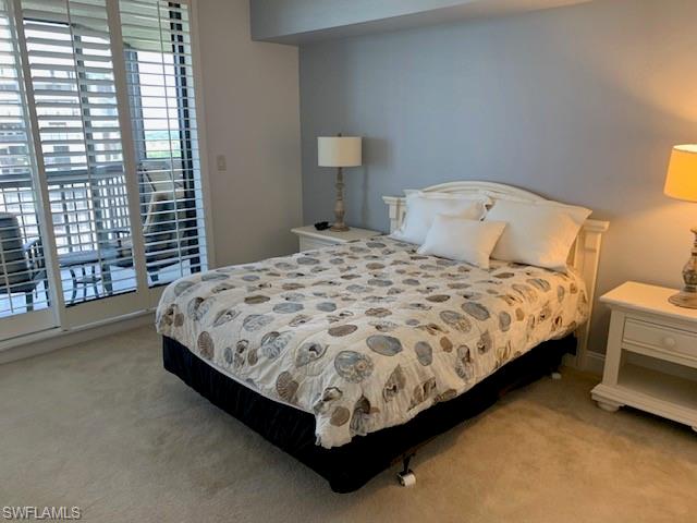 Bedroom featuring access to exterior and light carpet