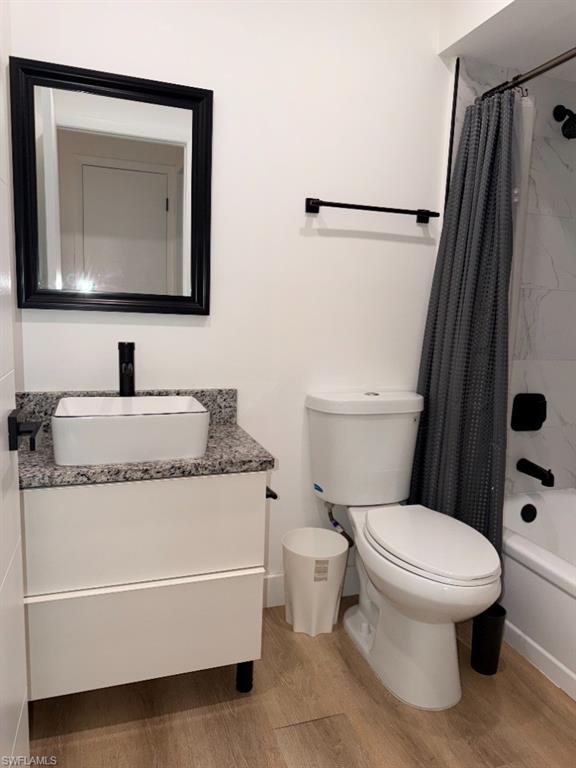 Modern bathroom featuring a white vanity with a rectangular vessel sink, granite countertop, and matte black faucet