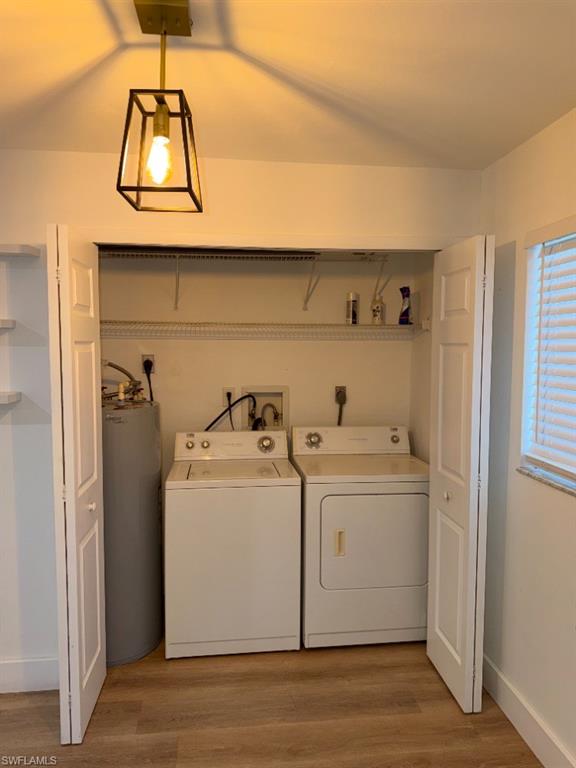 Dedicated laundry closet featuring a top-load washer, front-load dryer, and water heater