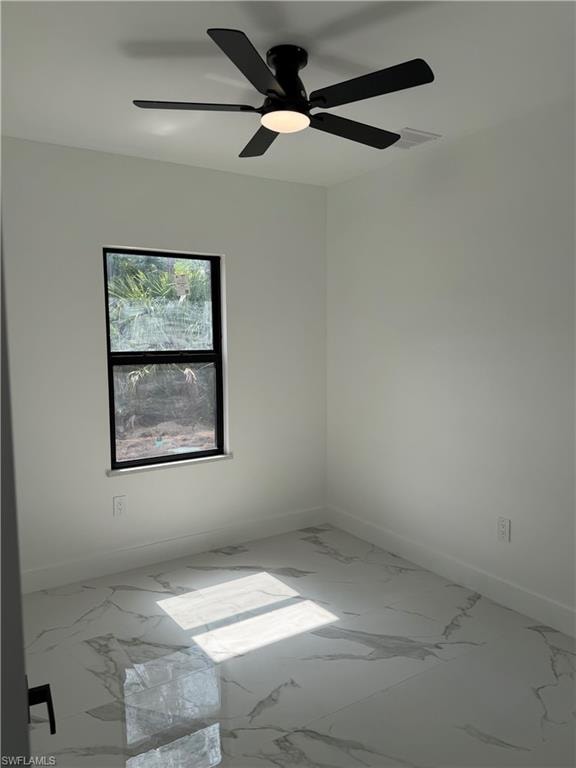 Room featuring white walls, a black-framed window, and a black ceiling fan with an integrated light