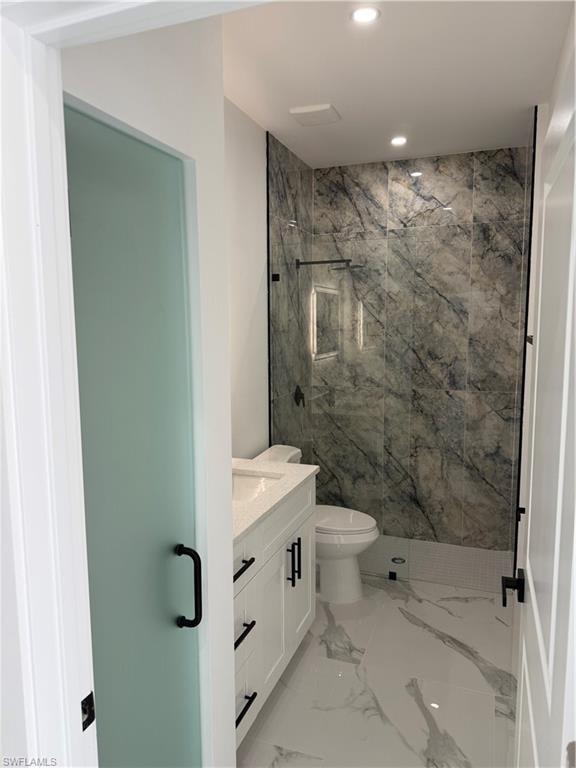 Contemporary bathroom featuring a floating white vanity with a quartz countertop, a walk-in shower with large format marble-look wall tiles, and contrasting black hardware