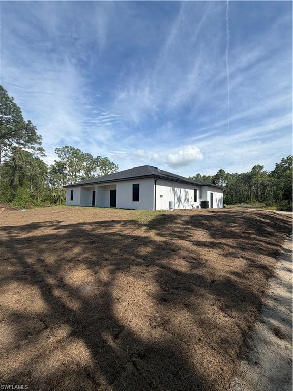 Single-story structure with a dark roof and white exterior walls