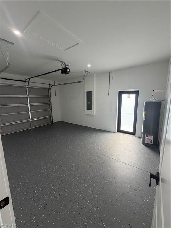 Spacious garage featuring a finished epoxy floor, an overhead garage door with opener, a side entry door, and recessed ceiling lighting