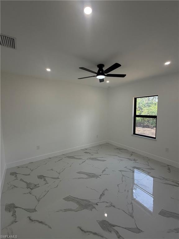 Spacious room featuring large format tile flooring, a black ceiling fan with an integrated light, and recessed lighting