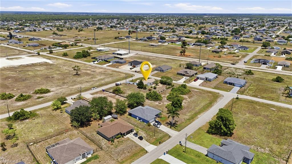 Aerial overview of a residential neighborhood with single-story homes on individual lots