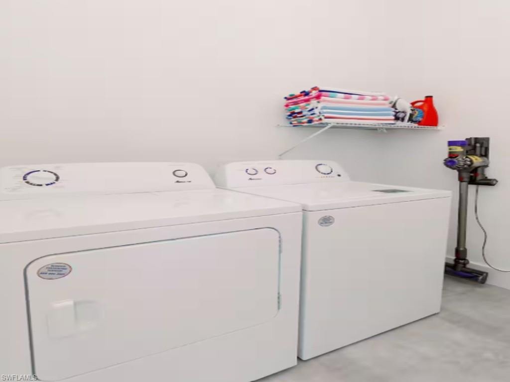 Dedicated laundry area featuring a white washer and dryer set