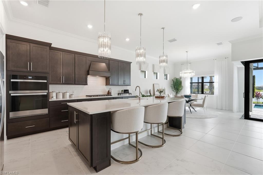 Gourmet Kitchen, Quartz Countertops, Furniture  Style Island with Seating and Elegant Pendant Lighting