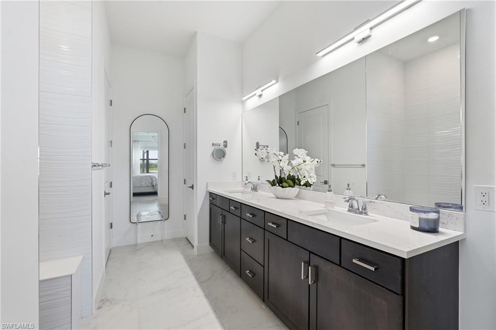 Dual Sink Vanities and Abundant Cabinet Storage with Modern Lighting
