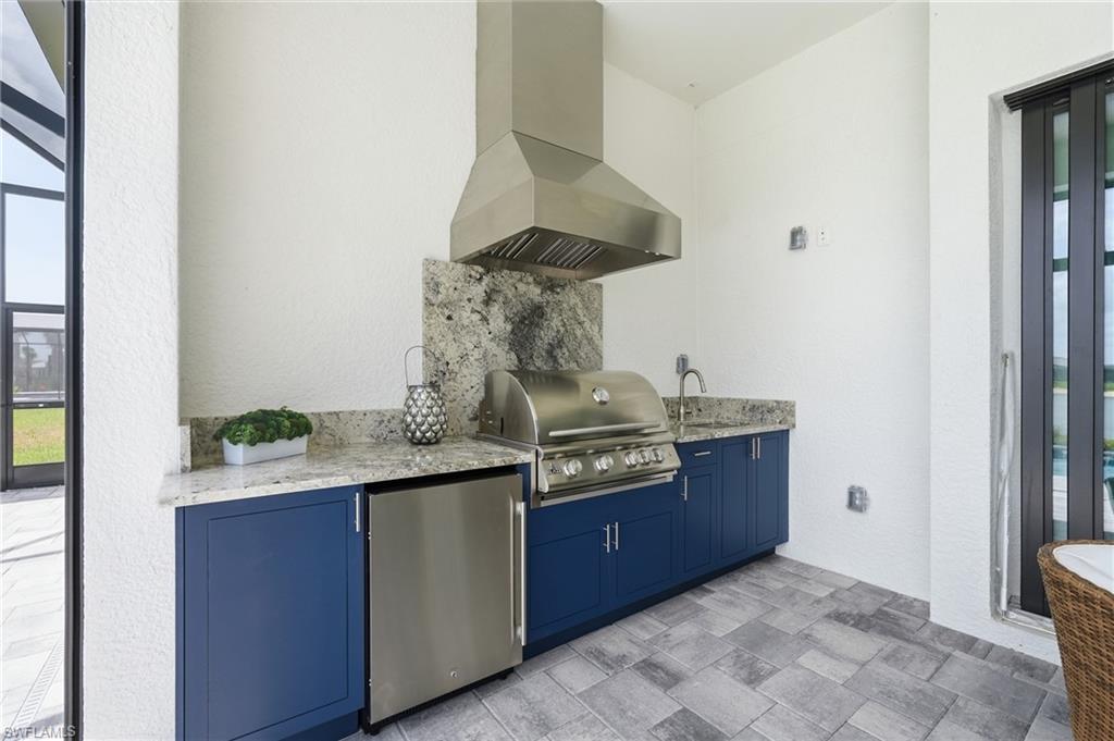 Just Completed Outdoor Kitchen with Stainles BBQ, Vented Hood and Sink and Beverage Fridge