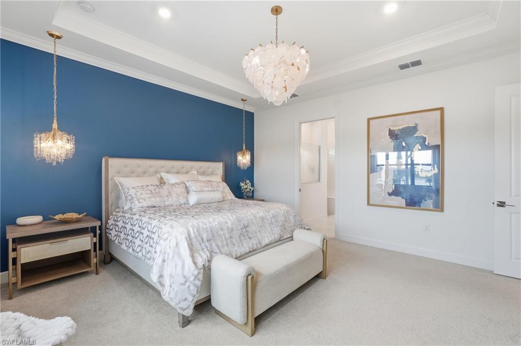 Elegant Primary Suite with Accent Wall, Chandelier and Pendant Bed Lighting
