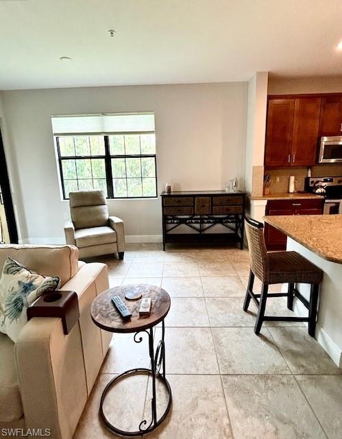 Living room featuring light tile floors